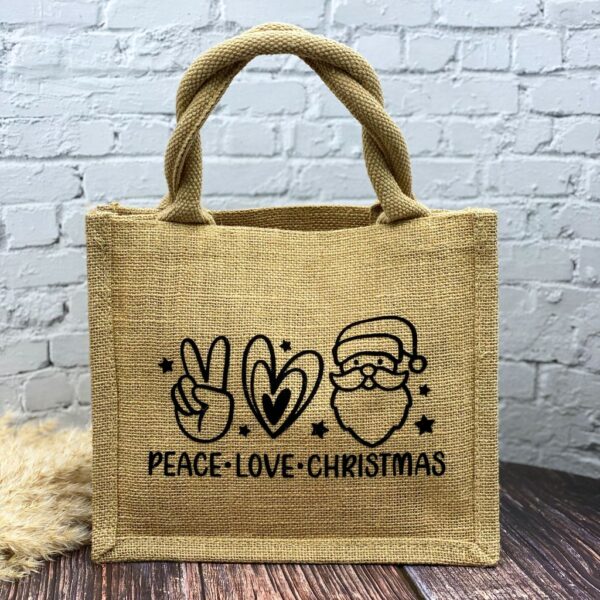 beige Jutetasche mit weissem Aufdruck "Peace - Love - Christmas" und dazugehörenden Symbolen